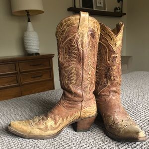 Well worn goatskin corral cowboy boots.